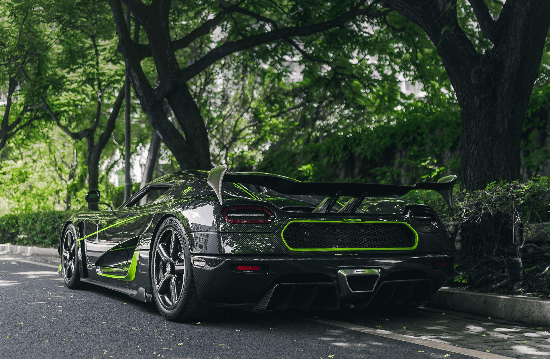 A black Koenigsegg Agera R+ hypercar is parked on road